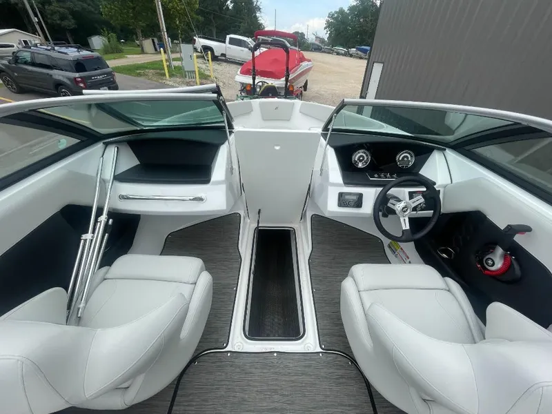 Slide: The Image of 2025 Four Winns H4 Freedom boat interior with modern dashboard and comfortable seating. - 8