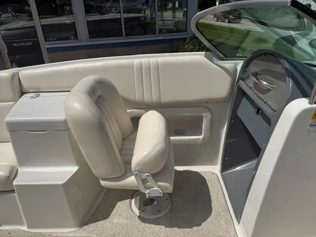 Slide: The Image of 2001 Chris-Craft Launch 25 boat interior with beige seating and dashboard. - 10