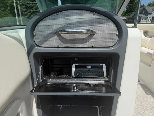 Slide: The Image of 2001 Chris-Craft Launch 25 dashboard with stereo system and cup holders. - 11