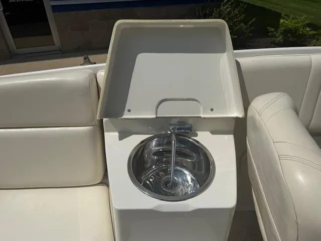 Slide: The Image of 2001 Chris-Craft Launch 25 boat interior with sink and white seating. - 12