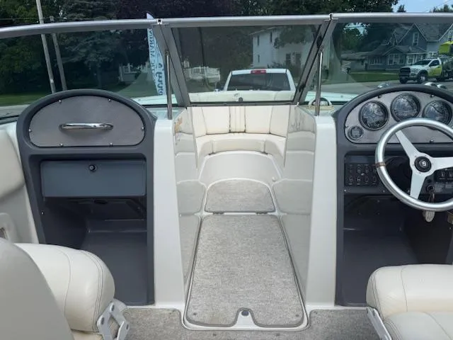 Slide: The Image of 2001 Chris-Craft Launch 25 boat interior with steering wheel and dashboard view. - 13