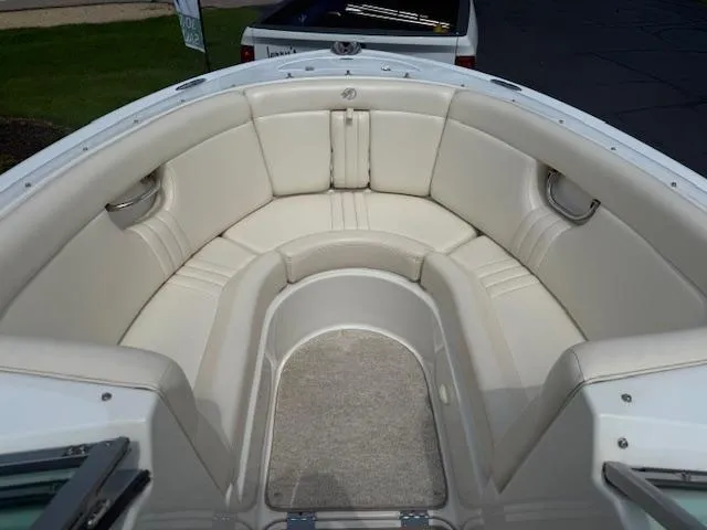 Slide: The Image of 2001 Chris-Craft Launch 25 boat interior with white cushioned seating and carpeted floor. - 14