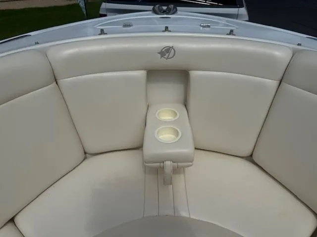 Slide: The Image of 2001 Chris-Craft Launch 25 boat interior with white cushioned seating and cup holders. - 15