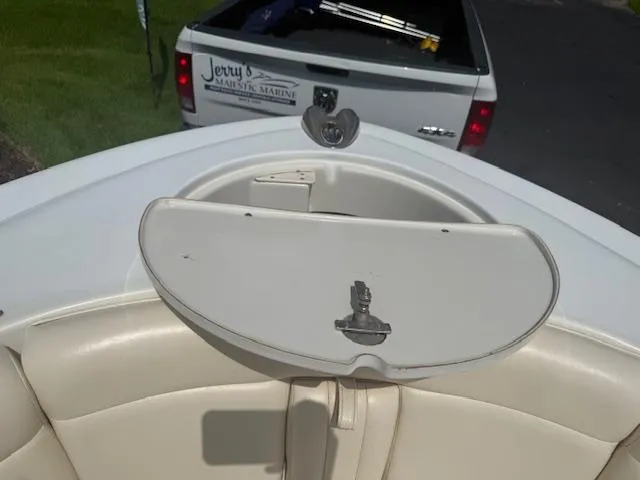 Slide: The Image of 2001 Chris-Craft Launch 25 boat interior with beige seating and storage compartment. - 16