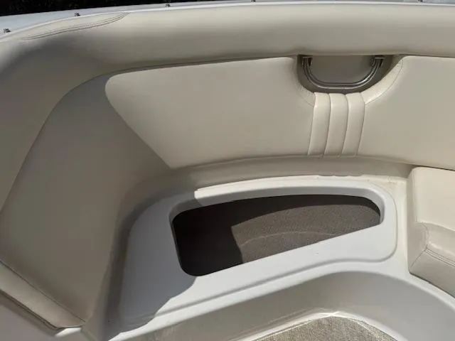 Slide: The Image of 2001 Chris-Craft Launch 25 boat interior with white seating and storage compartment. - 17