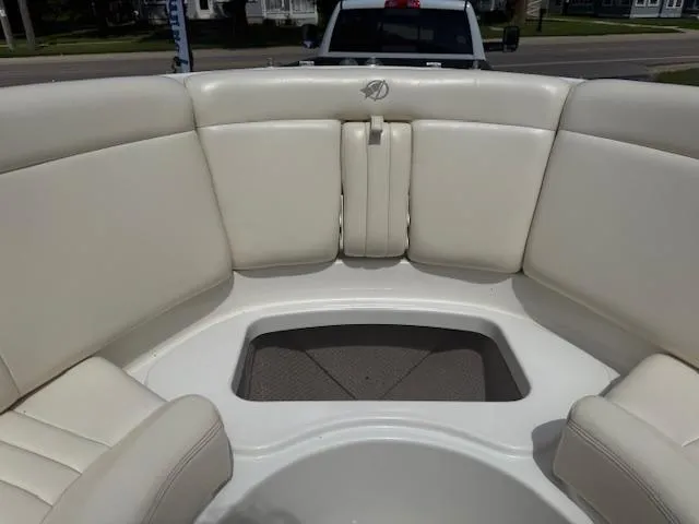 Slide: The Image of 2001 Chris-Craft Launch 25 boat interior with white cushioned seating. - 18