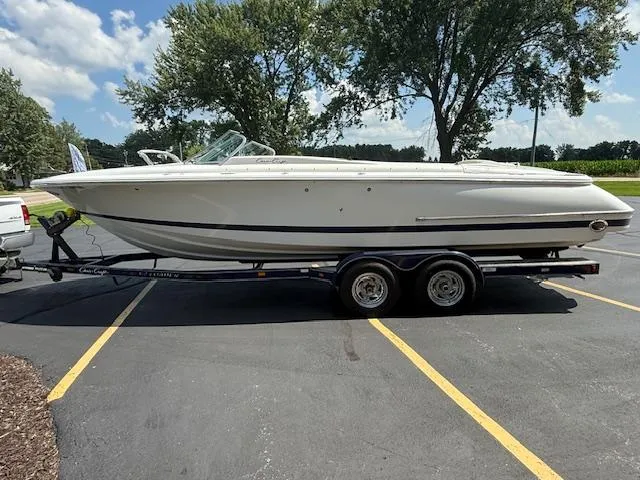 Slide: The Image of 2001 Chris-Craft Launch 25 boat on trailer in parking lot, sunny day. - 2