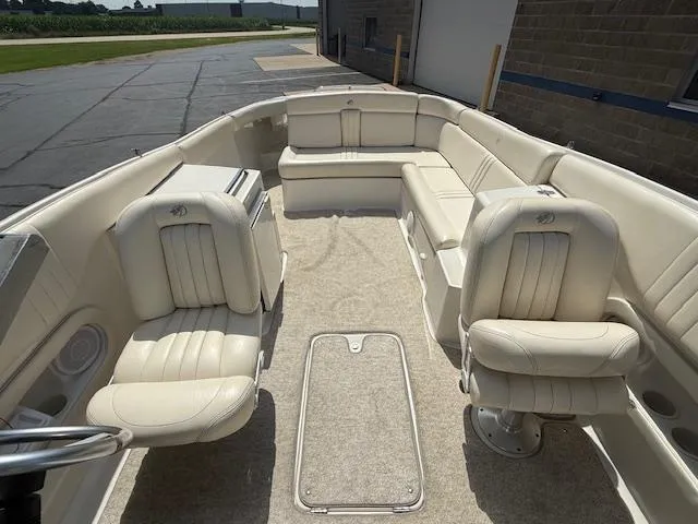Slide: The Image of 2001 Chris-Craft Launch 25 boat interior with white leather seating and carpeted floor. - 21
