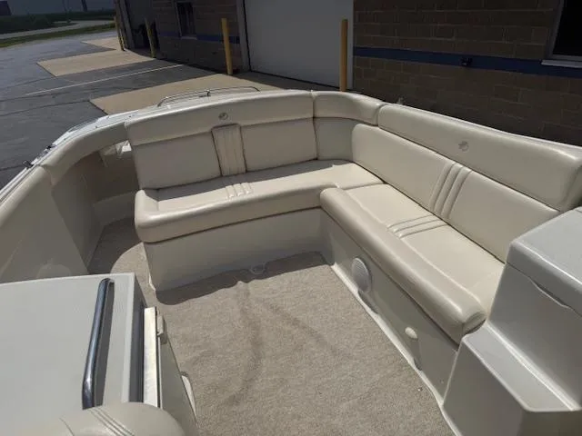 Slide: The Image of 2001 Chris-Craft Launch 25 boat interior with beige seating and carpeted floor. - 22