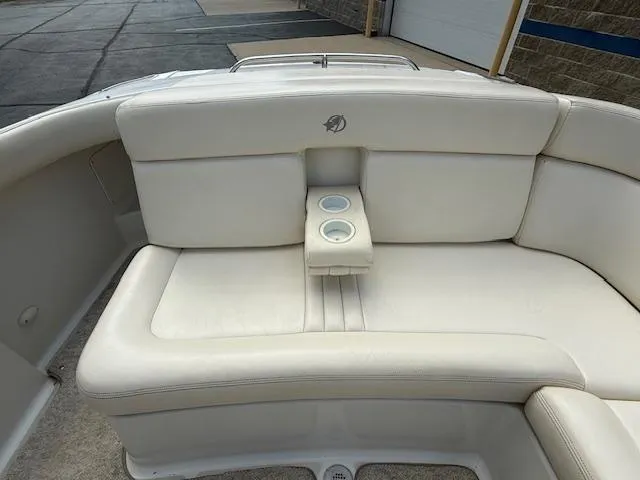 Slide: The Image of 2001 Chris-Craft Launch 25 boat interior with white leather seating and cup holders. - 24
