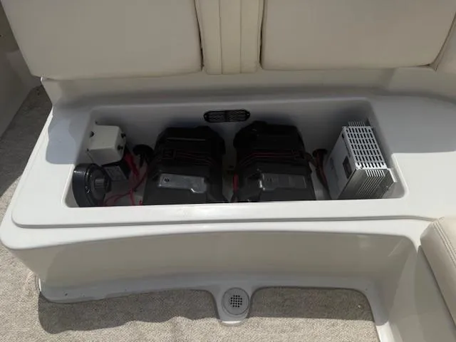 Slide: The Image of Battery compartment of 2001 Chris-Craft Launch 25 boat, featuring dual batteries and electrical components. - 25