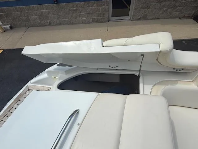 Slide: The Image of 2001 Chris-Craft Launch 25 boat interior with white seating and storage compartment. - 27