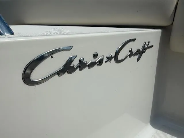 Slide: The Image of 2001 Chris-Craft Launch 25 boat logo on white surface. - 35