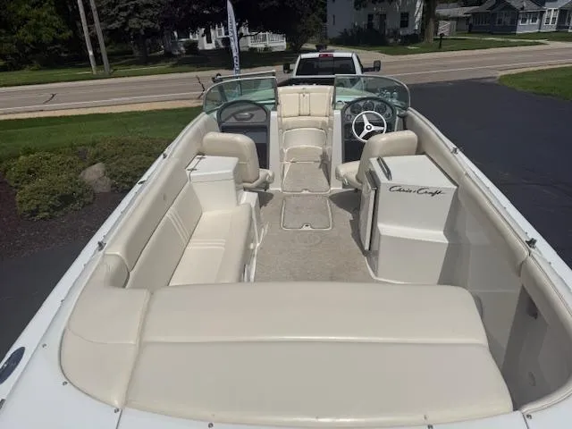 Slide: The Image of 2001 Chris-Craft Launch 25 boat interior with beige seating and steering wheel. - 4