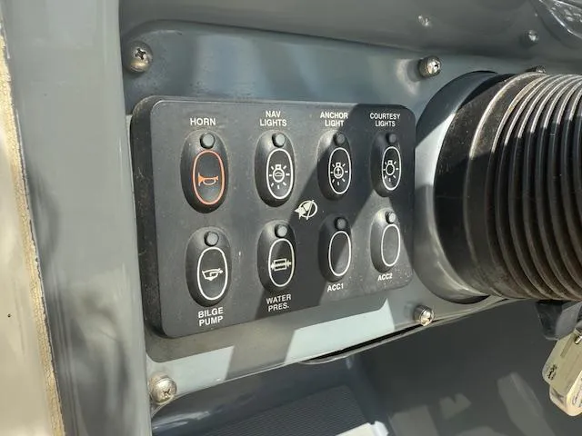 Slide: The Image of Control panel of a 2001 Chris-Craft Launch 25 boat with various switches. - 7