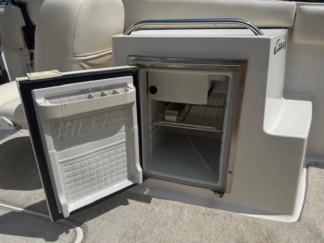 Slide: The Image of Open mini fridge on 2001 Chris-Craft Launch 25 boat, showcasing interior storage space. - 9