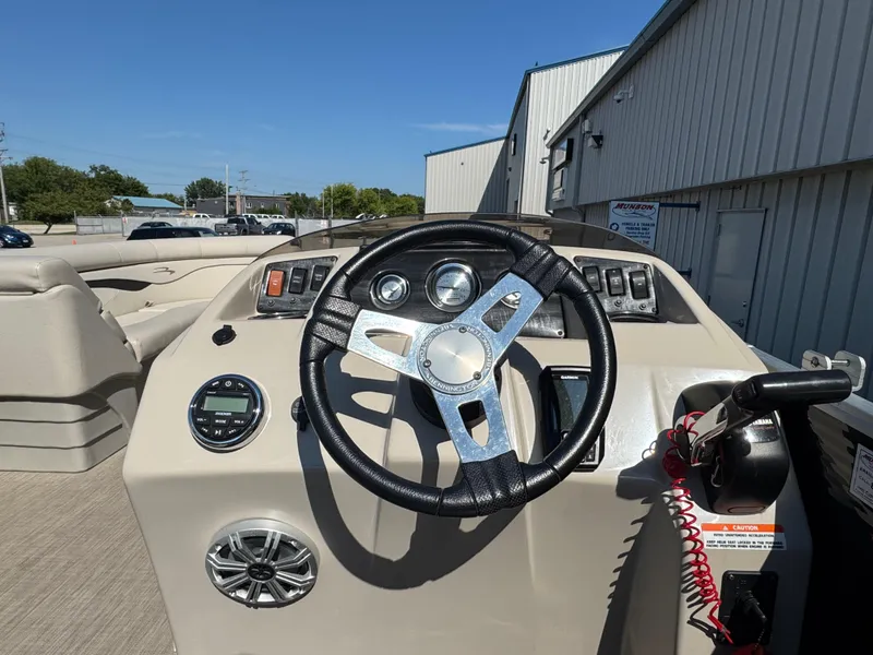 Slide: The Image of 2017 Bennington 21 SLX boat dashboard with steering wheel and controls. - 10