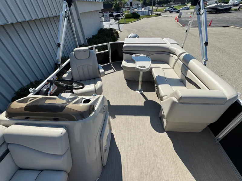 Slide: The Image of 2017 Bennington 21 SLX pontoon boat interior with beige seating and steering console. - 11