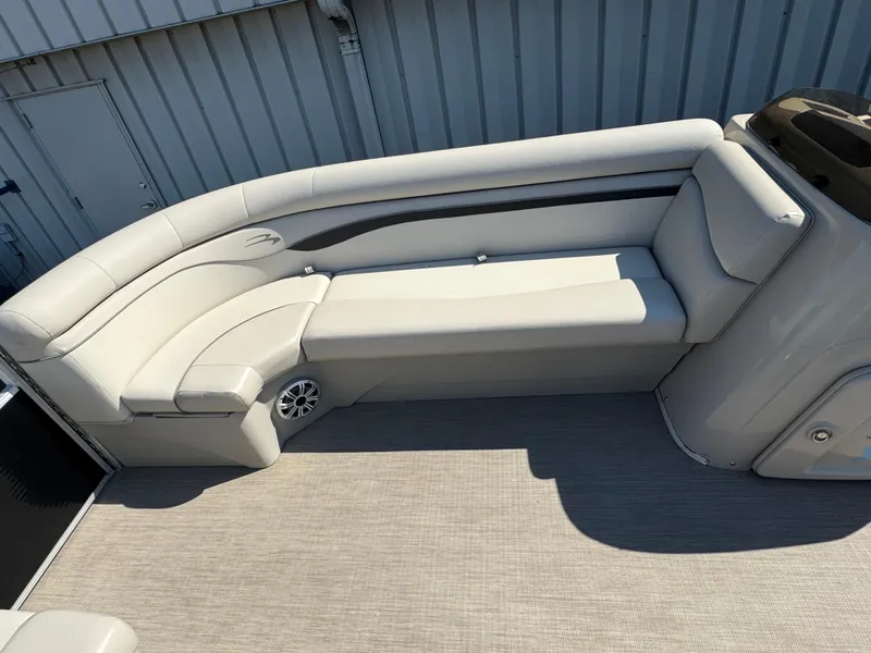 Slide: The Image of 2017 Bennington 21 SLX boat interior with beige seating and speaker. - 12
