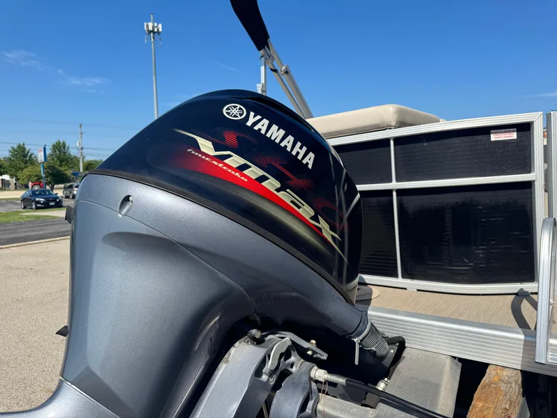 Slide: The Image of 2017 Bennington 21 SLX with Yamaha VMAX outboard motor, parked outdoors. - 13