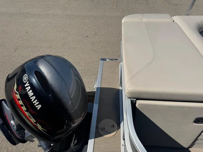 Slide: The Image of 2017 Bennington 21 SLX boat with Yamaha outboard motor, beige seating, and metal railing. - 15