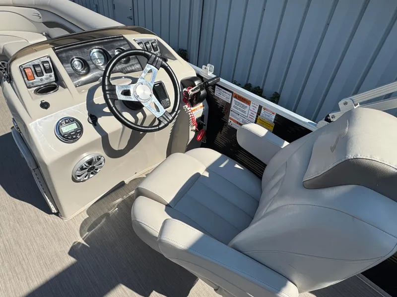 Slide: The Image of 2017 Bennington 21 SLX boat cockpit with steering wheel and comfortable seating. - 7