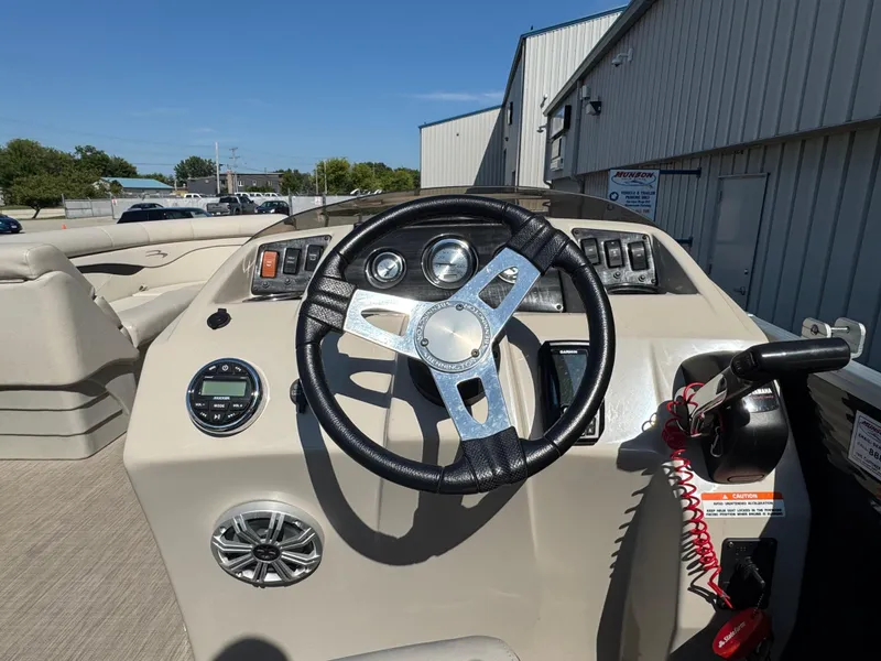 Slide: The Image of 2017 Bennington 21 SLX boat dashboard with steering wheel and control panel. - 8