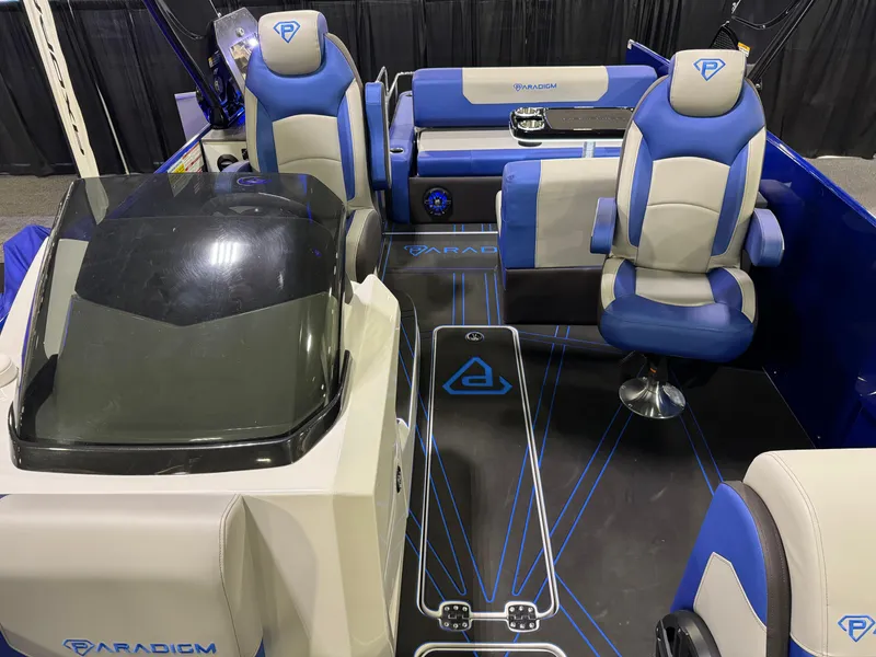 Slide: The Image of 2025 Paradigm 236 boat interior with blue and gray seating, modern design. - 6