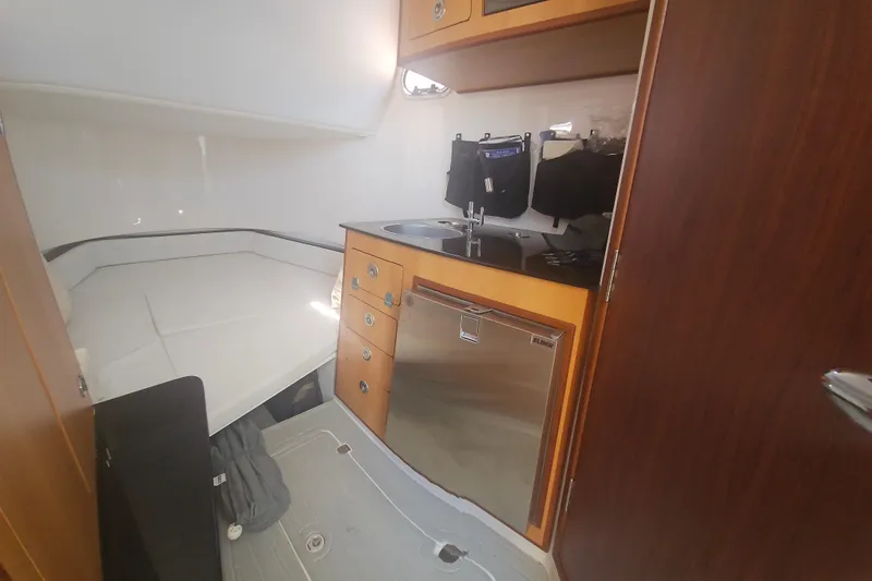 Slide: The Image of 2024 Victory Yachts V400 Open Sea interior with kitchenette and sleeping area. - 11