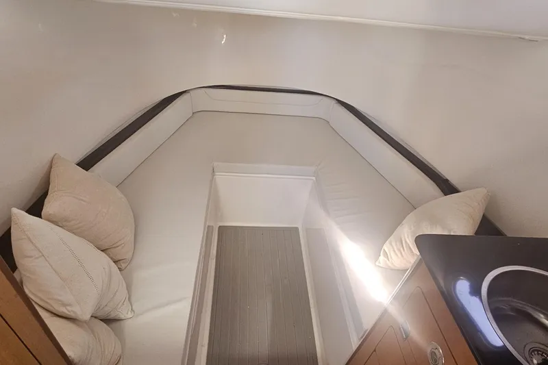 Slide: The Image of 2024 Victory Yachts V400 Open Sea cabin interior with cushions and sleek design. - 12