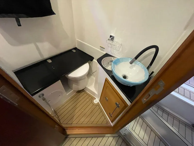 Slide: The Image of Compact bathroom in 2024 Victory V400 Open Sea boat with modern sink and toilet. - 14