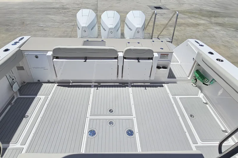 Slide: The Image of 2024 Victory Yachts V400 Open Sea deck with Mercury engines, spacious layout, and modern design. - 16
