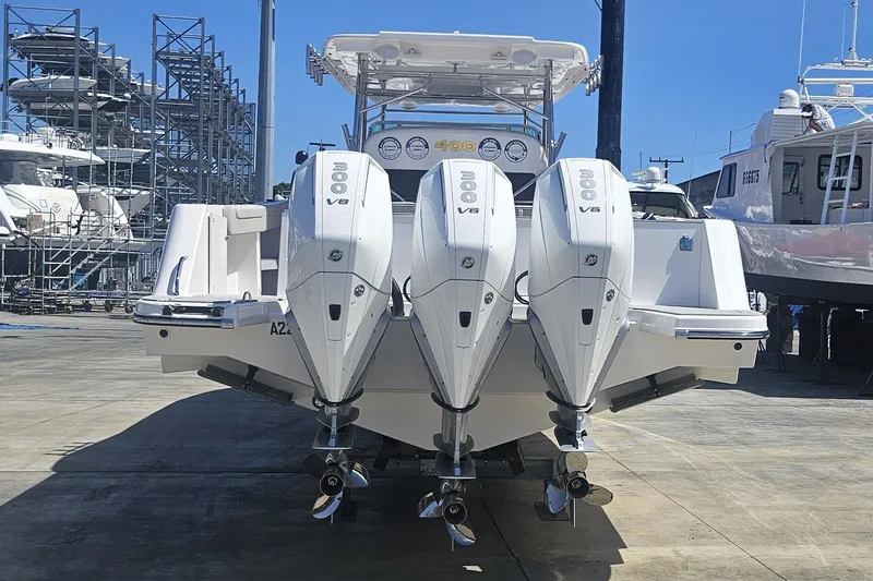 Slide: The Image of 2024 Victory Yachts V400 Open Sea with triple 300 V8 engines, docked at marina. - 17