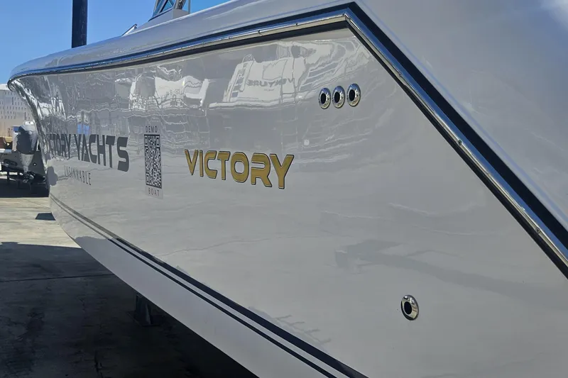 Slide: The Image of 2024 Victory Yachts V400 Open Sea, sleek design with reflective finish, docked outdoors. - 19