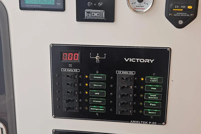 Slide: The Image of Control panel of 2024 Victory Yachts V400 Open Sea with various switches and indicators. - 7