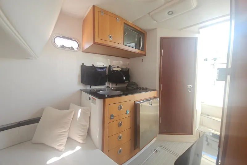 Slide: The Image of Interior of 2024 Victory Yachts V400 Open Sea, featuring kitchenette and seating area. - 9