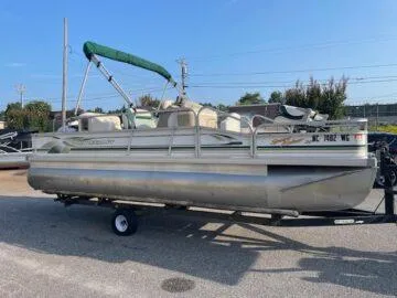 Slide: The Image of 1999 Princecraft Sportfisher 20 pontoon boat on trailer, parked outdoors. - 10