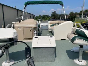 Slide: The Image of 1999 Princecraft Sportfisher 20 pontoon boat with seating and canopy, docked outdoors. - 6