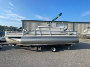 Slide: The Image of 1999 Princecraft Sportfisher 20 pontoon boat parked outdoors on a trailer. - 8