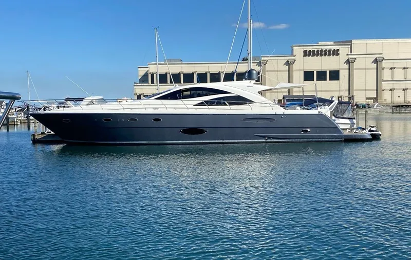 The Image of 2007 Uniesse 70 Sport yacht docked in marina, clear blue sky background. - 0