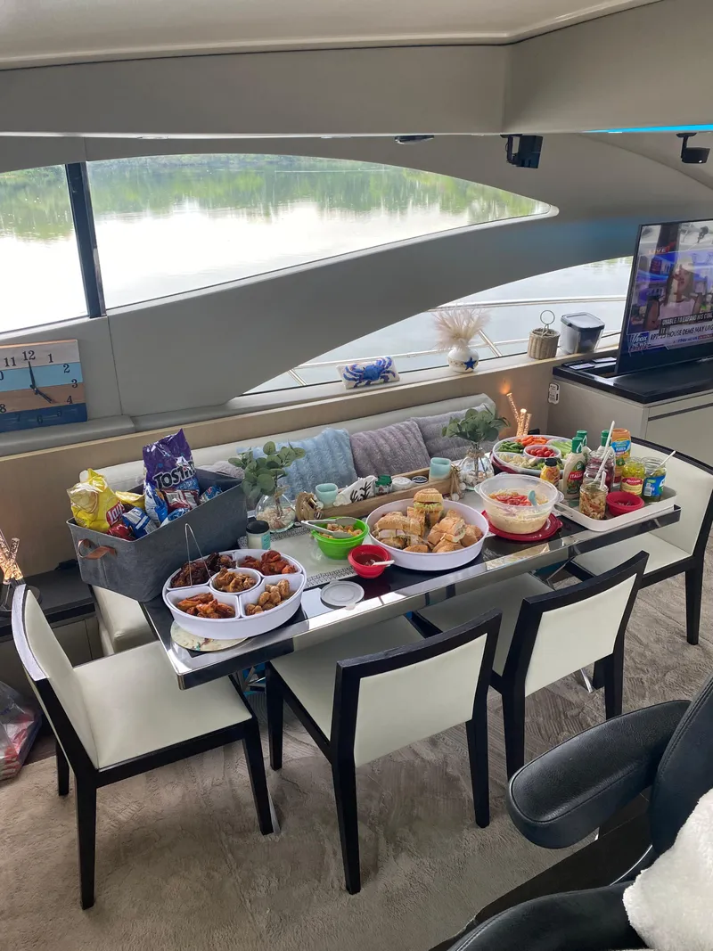 Slide: The Image of Luxurious 2007 Uniesse 70 Sport yacht interior with dining table set for a feast. - 14