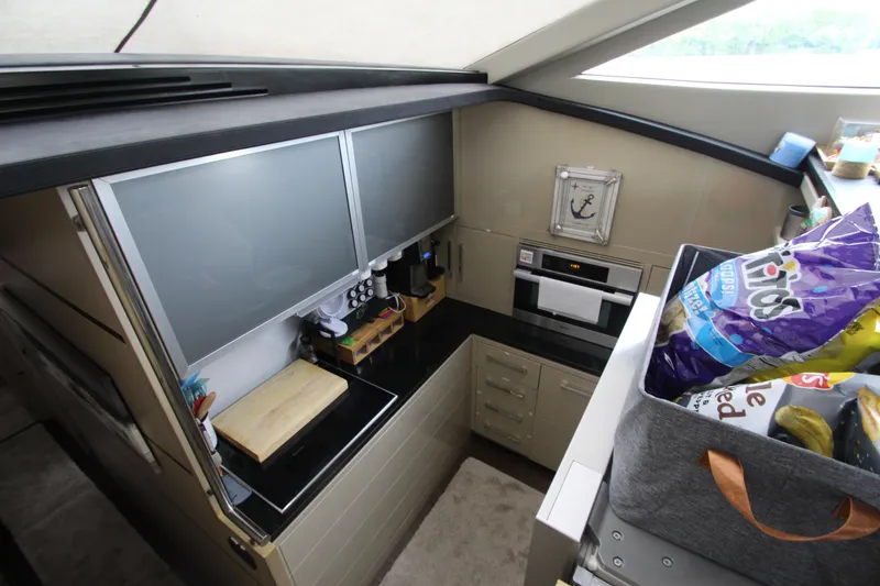 Slide: The Image of Compact kitchen in 2007 Uniesse 70 Sport yacht with modern appliances and storage. - 19