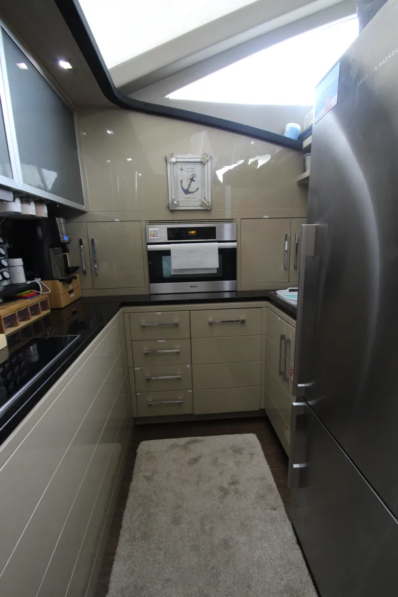 Slide: The Image of Modern kitchen interior on 2007 Uniesse 70 Sport yacht, featuring sleek cabinetry and stainless steel appliances. - 20