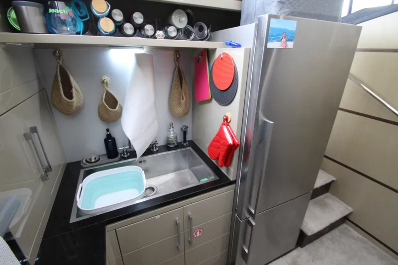 Slide: The Image of Compact kitchen area in a 2007 Uniesse 70 Sport yacht with modern appliances. - 21