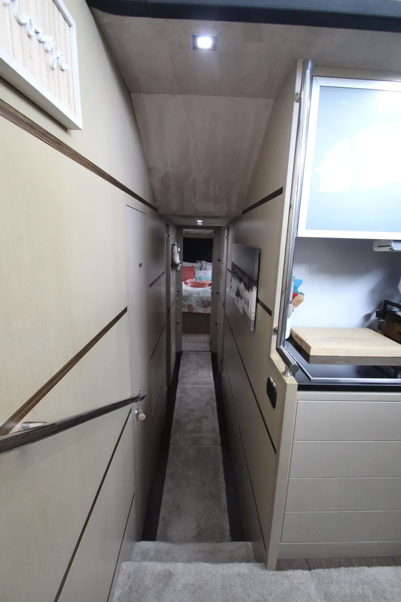 Slide: The Image of Interior hallway of 2007 Uniesse 70 Sport yacht, featuring modern design and compact layout. - 25