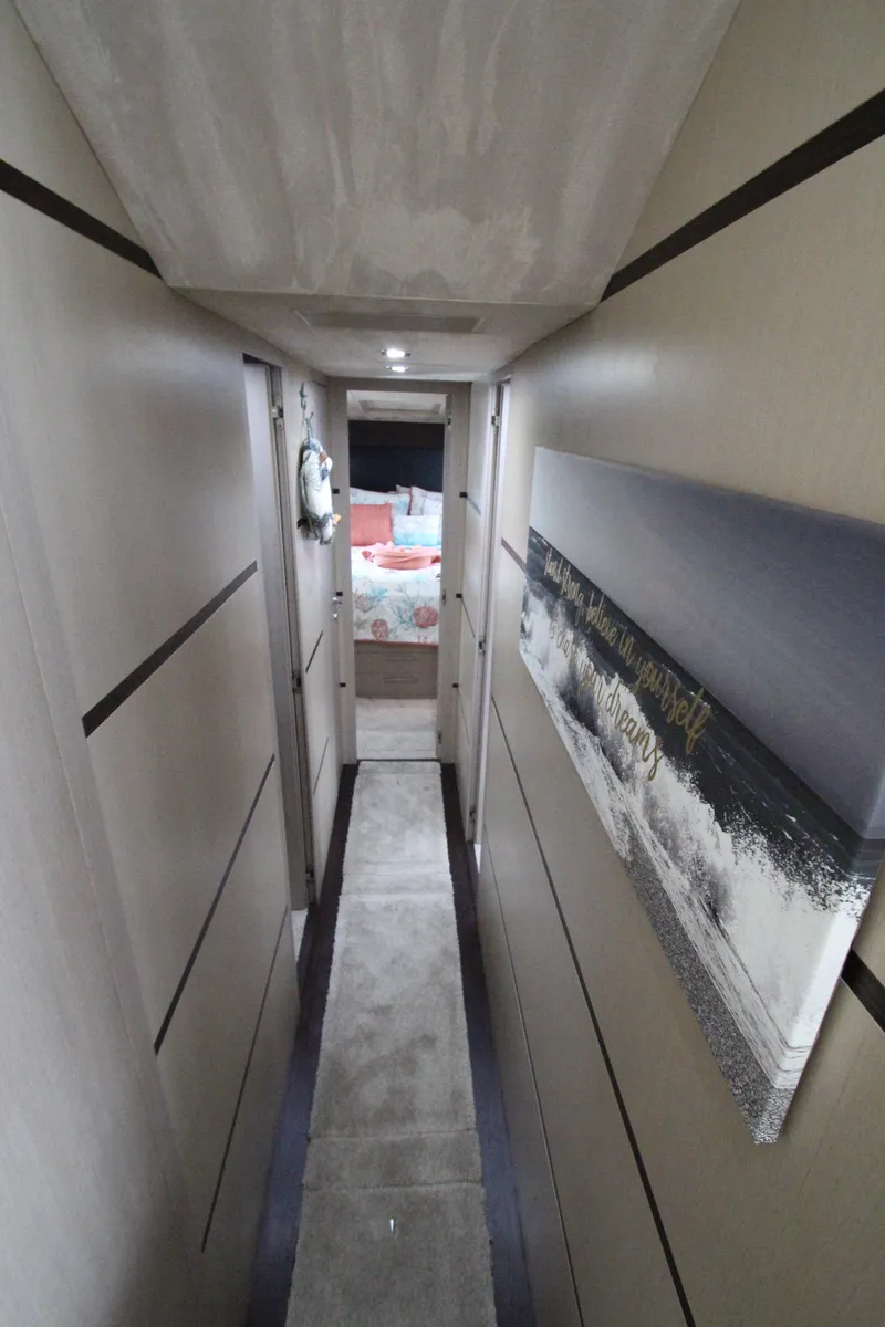 Slide: The Image of Interior hallway of 2007 Uniesse 70 Sport yacht, featuring modern design and artwork. - 26