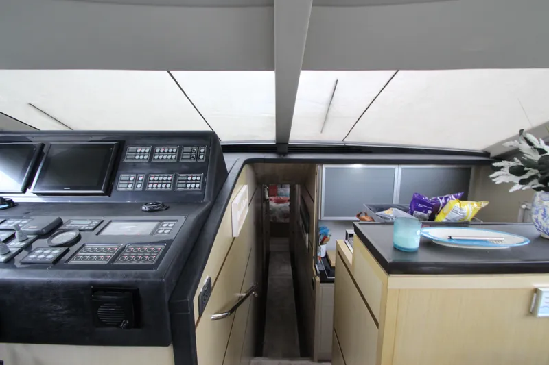 Slide: The Image of Interior of 2007 Uniesse 70 Sport yacht with control panel and cabin view. - 27