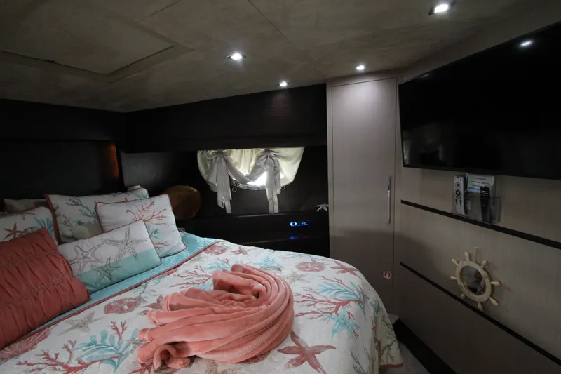 Slide: The Image of Luxurious bedroom interior of 2007 Uniesse 70 Sport yacht with elegant decor and ambient lighting. - 32
