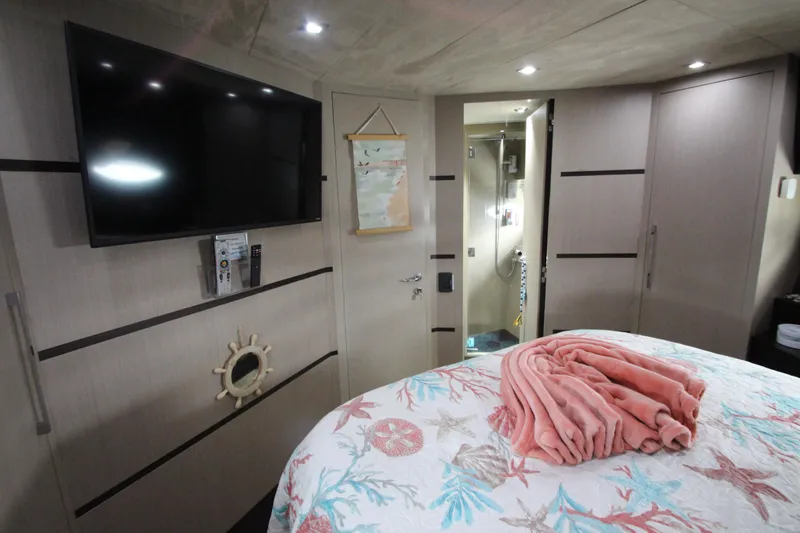 Slide: The Image of Luxurious 2007 Uniesse 70 Sport yacht bedroom with TV and nautical decor. - 34