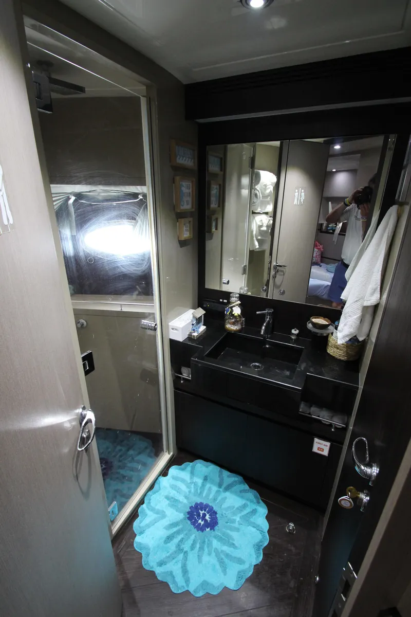 Slide: The Image of Bathroom interior of 2007 Uniesse 70 Sport yacht with modern fixtures and blue rug. - 38